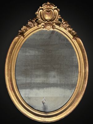 an image of a gold framed mirror on a black wall