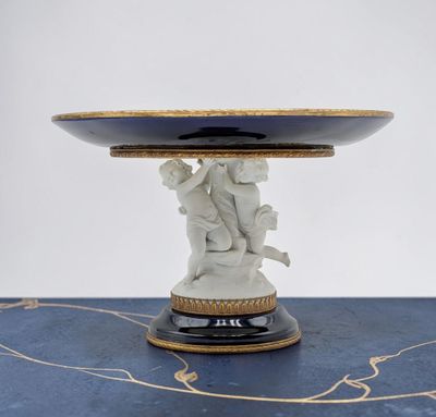 a white and gold plate with a statue on top of it