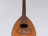 a guitar hanging from the ceiling in a room