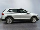 the white volkswagen suv is parked in a room with a gray wall