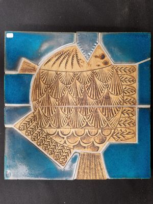 an image of a blue and yellow tile with a bird on it