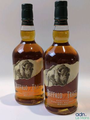 two bottles of buffalo trace bourbon sitting next to each other