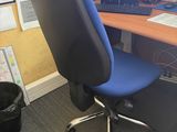 a desk with a computer and a chair in front of it
