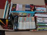 a cardboard box filled with books and dvds