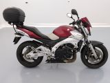 a red and white motorcycle parked in a white room