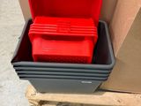 a red container sitting on a pallet next to a cardboard box