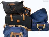 four pieces of luggage sitting on top of each other on a white surface