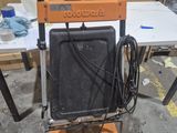 une machine orange et noire posée par terre