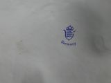 a white porcelain plate with a blue design on it
