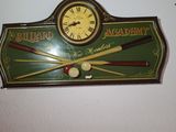 a clock that is on the wall above a pool ball racket