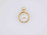 a close up of a pocket watch on a white surface