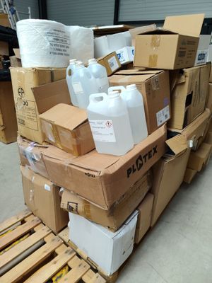 a pile of boxes and containers sitting on a pallet
