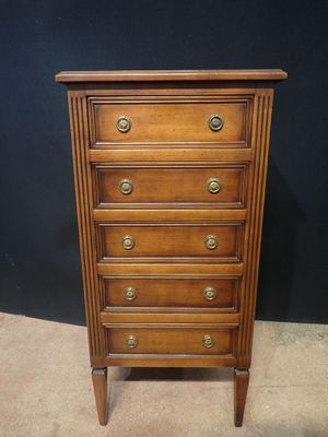 an old wooden chest of drawers with brass pulls