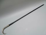 a black umbrella with a silver handle on a white surface