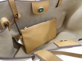 a purse that is sitting on a table next to a cell phone