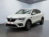 a white car is parked in a white room with a black floor