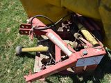 a tractor that is sitting in the grass with a yellow cover on it