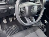 a dashboard of a car with a steering wheel and dashboard controls