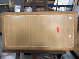 a picture of a box sitting on top of a wooden easel