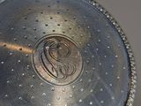 an antique silver plate with a monogram on it