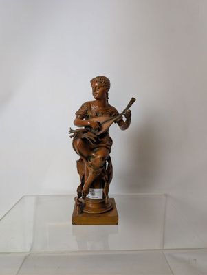 a statue of a man playing a guitar on a glass table