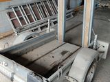 a small trailer with a flat bed inside of a building