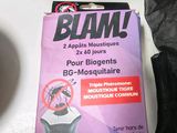 a box of blam on a table next to a cup of coffee