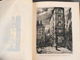 an open book with a picture of a street scene in it