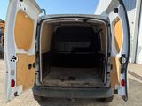 a white van with its doors open in a parking lot