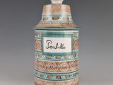 a blue and brown jar with a name on it