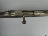 an old gun that is sitting on a white surface
