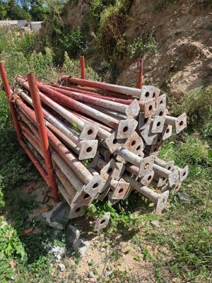 a pile of old rusty pipes sitting in the grass