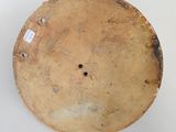 a close up of a wooden plate on a white surface