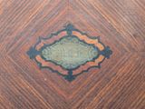 a close up of a wooden table with a sign on it