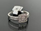 a picture of a diamond ring on a black surface