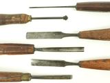 several different types of woodworking tools are lined up on a white surface