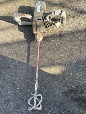 a broken fire hydrant sitting on the ground next to a hose