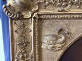 a picture of a gold frame with a bird on it
