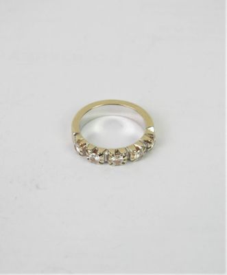 a close up of a gold ring on a white surface