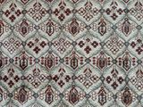 a white and red rug with a pattern on it