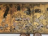 two pairs of shoes sitting on a bench in front of a painting