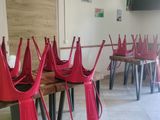 many red chairs lined up in a row in a room