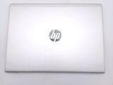 a white laptop with a hp logo on the screen