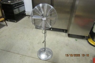a fan that is sitting on the floor in the kitchen