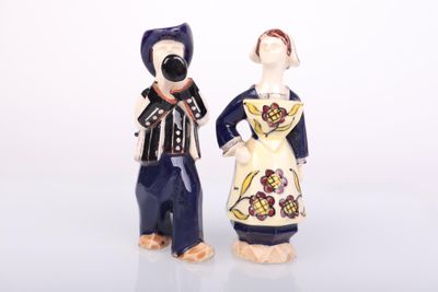 two figurines of a man and a woman standing next to each other