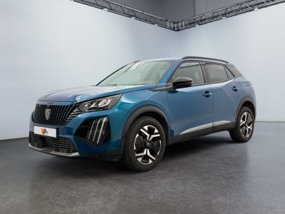 Le SUV bleu est garé dans une grande pièce aux murs blancs.