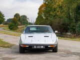 a white sports car parked on the side of the road