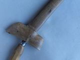 a wooden knife that is laying on a table
