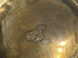a close up of a metal bowl with a hole in it