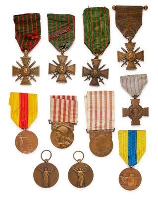 an assortment of medals and medals are displayed on a white surface